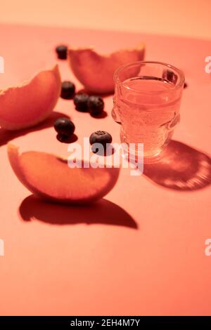 Pink Shot Glas mit Grapefruit auf einem rosa Hintergrund Stockfoto