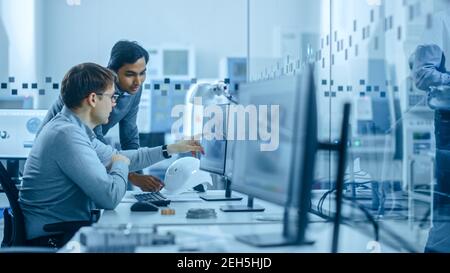 Inside Office: Digital Engineering Professional Arbeiten am Personal Computer, Entwerfen von 3D Komponenten in CAD SoftwareIn Factory Workshop. Stockfoto