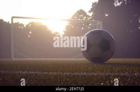 Fußball auf dem Feld mit dem Sonnenuntergang im Hintergrund. Schärfentiefe mit Fokus auf den Ball. Stockfoto