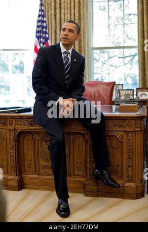 Präsident Barack Obama lehnt sich gegen den Resolute Desk im Oval Office, 30. April 2010. Stockfoto