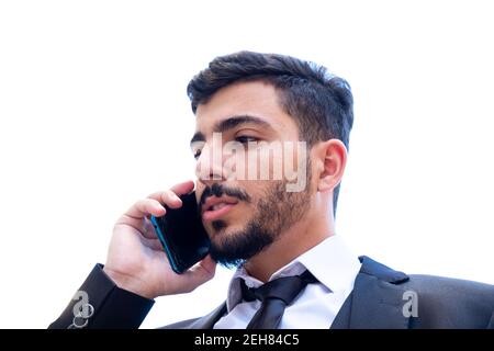Geschäftsmann argumentiert und diskutiert die Arbeit mit dem Handy Bei einem Anruf oder Videoanruf zur Aufrechterhaltung des Geschäftsbetriebs folgen Und bleiben Sie mit der Arbeit verfolgt Stockfoto