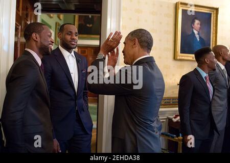 Präsident Barack Obama spricht mit 2013 NBA-Champion Miami Heat-Spieler Dwyane Wade, links, und LeBron James im Blue Room vor einer Zeremonie zu Ehren des Teams auf ihren zweiten geraden Meistertitel zu gewinnen, im East Room des Weißen Hauses, 14. Januar 2014. Stockfoto