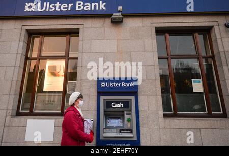 Dublin, Irland. Februar 2021, 19th. Eine Frau mit Gesichtsmaske geht am Geldautomaten der Ulster Bank in Ranelagh, Dublin, vorbei. Ulster Bank bestätigte heute einen Rückzug aus dem irischen Markt. Die Bank wird nach 160 Jahren ihre Türen schließen. Die Ulster Bank gehört dem britischen Kreditgeber NatWest und hat hier 1,1 Millionen Kunden sowie 2.800 Mitarbeiter in 88 Filialen im ganzen Land. Kredit: SOPA Images Limited/Alamy Live Nachrichten Stockfoto