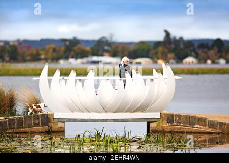 Ballarat Australien / EINE Frau, die ihren Hund während der Covid 19 Einschränkungen, Lake Wendouree, Ballarat Victoria zu Fuß unterwegs ist Stockfoto