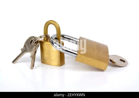 Sichern Sie goldene Vorhängeschlösser und Schlüssel auf weißem Hintergrund für Sicherheit und Schutz Stockfoto