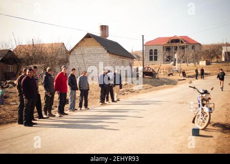 SEREDNIE, UKRAINE - 09. MÄRZ 2011: Junge Männer warten auf Bus zur Arbeit Stockfoto