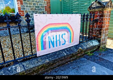 Warminster, Wiltshire UK - April 23 2020: Ein Bild des Regenbogens der Hoffnung, das den NHS und Key-Workers preist, die gegen das Coronavirus kämpfen, an Geländer gebunden Stockfoto