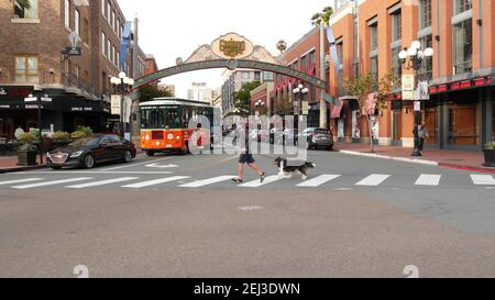 SAN DIEGO, CALIFORNIA USA - 30 JAN 2020: Gaslamp Quarter Historic Eingang Bogen Zeichen auf 5th Avenue. Orange kultige Retro-Trolley, Hop-on-Hop-off-Bus und Stockfoto