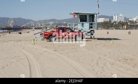 SANTA MONICA, LOS ANGELES CA USA - 28 Okt 2019: California summertime Beach aesthetic. Ikonischer blauer hölzerner Wachturm, roter Rettungsschwimmer Auto auf sandigen sonnigen Stockfoto