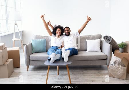 Schwarze Ehepartner Feiern Umzug Tag In New House, Gestikuling Thumbs-Up Stockfoto