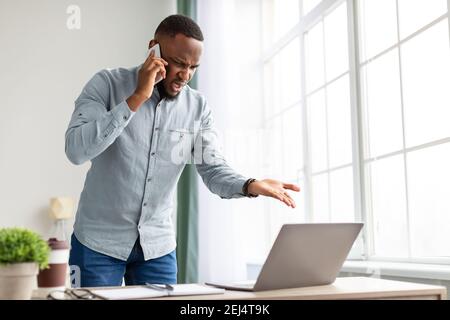 Wütend Afroamerikanischen Geschäftsmann Im Gespräch Auf Handy Im Büro Stehen Stockfoto