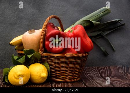 Stillleben mit Gemüse, Zitronen und Weidenkorb Stockfoto
