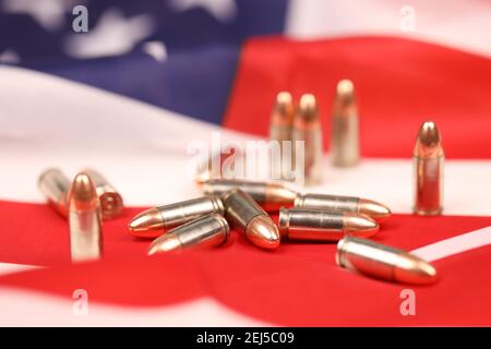 Viele gelbe 9mm Kugeln und Patronen auf US-Flagge. Konzept des Waffenhandels auf US-Territorium oder spezielle Operationen Stockfoto