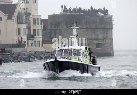 AJAXNETPHOTO. JANUAR 2009, 28TH. PORTSMOUTH, ENGLAND. - MISTY WILLKOMMEN - MINISTERIUM FÜR VERTEIDIGUNG POLIZEI STARTEN EINGABE HAFEN ALS MASSEN AUF DEM RUNDEN TURM BEGRÜSSEN HMS DARING, ERSTE DER ROYAL NAVY'S SECHS NEUE TYP 45 ZERSTÖRER. FOTO: JONATHAN EASTLAND/AJAX REF:D92801 2257 Stockfoto