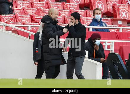 London, Großbritannien. Februar 2021, 21st. Der Manager von Manchester City, Josep Guardiola (L), begrüßt Arsenals Manager Mikel Arteta vor dem Fußballspiel der englischen Premier League zwischen Arsenal und Manchester City im Emirates Stadium in London, Großbritannien, am 21. Februar 2021. Quelle: Han Yan/Xinhua/Alamy Live News Stockfoto