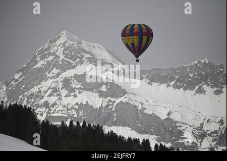 Crest Voland, Frankreich. Februar 2021, 22nd. Ein Heißluftballon fliegt vor einem Berg, dem Mont Charvin. Auch ohne Skilifte können Touristen die Pisten während der Absperrung nutzen. Skigebiete bieten verschiedene Aktivitäten wie Langlaufen, Schneeschuhwandern oder Heißluftballonfahrten. Quelle: Lisa Ducret/dpa/Alamy Live News Stockfoto