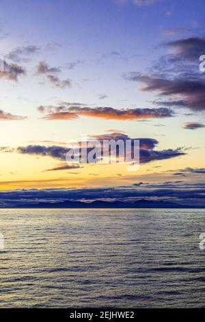 Seltsame Gestalt einer fliegenden Figur oder eines Engels bei Sonnenuntergang über der nordwestlichen Pazifikküste bei Prince of Wales Island, Alaska, USA - von einem Kreuzfahrtschiff aus gesehen. Stockfoto