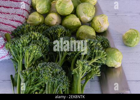 Eine Auswahl an frischem Gemüse aus dem Wintergarten und auf dem Tisch ausgelegt einschließlich Sprossen, Broccoli mit zarten Stielen. Stockfoto