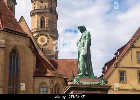 Deutschland, Baden-Württemberg, Stuttgart, Statue von Friedrich Schiller am Schillerplatz mit Glockenturm der Stiftskirche im Hintergrund Stockfoto