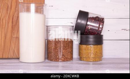 Zero-Waste-Lagerraum. Frühstückselemente, in wiederverschließbaren Plastikgläsern, Müsli, Pasta aufbewahrt. Banken können mehrfach mit Schüttgütern befüllt werden. P Stockfoto