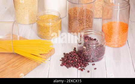 Zero-Waste-Lagerraum. Frühstückselemente, in wiederverschließbaren Plastikgläsern, Müsli, Pasta aufbewahrt. Banken können mehrfach mit Schüttgütern befüllt werden. P Stockfoto