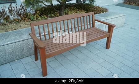 Exklusive Holzbank in einem kleinen Park Stockfoto