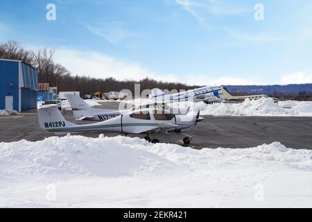 MONTGOMERY, NJ -17 FEB 2021- Winter view of a small airplane at the Princeton Airport (PCT) in Princeton, New Jersey, United States after a snowfall. Stock Photo