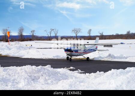 MONTGOMERY, NJ -17 FEB 2021- Winter view of a small airplane at the Princeton Airport (PCT) in Princeton, New Jersey, United States after a snowfall. Stock Photo