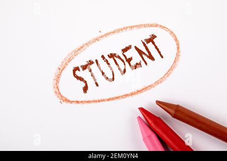 SCHÜLER. Farbige Buntstifte auf einem weißen Blatt Papier. Stockfoto