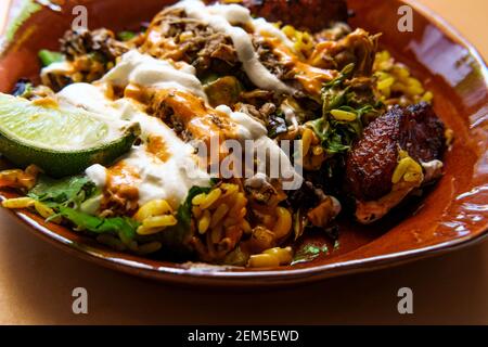 Jamaikanischer Jerkhuhn Reis Schüssel mit süßen Kochbananen und heiß Soße Stockfoto