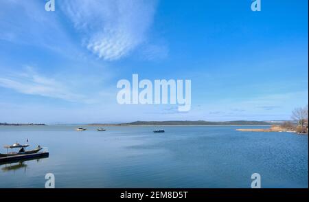 Herrlicher Himmel und Wolkenform auf dem See der Stadt Uluabat in Bursa. Boote auf dem See Teil der Stadt beobachten aus Foto. Stockfoto