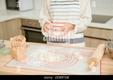 Frauen backen Kuchen. Konditoren machen Desserts. Brötchen machen. Teig auf dem Tisch. Den Teig kneten. Stockfoto