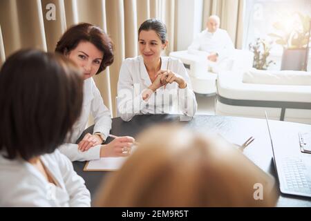 Gruppe von medizinischen Mitarbeitern, die miteinander kommunizieren Stockfoto