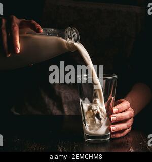 Frau Bäuerin mit einem Glas Milch. Konzeptprobleme im Agrarsektor. Stockfoto