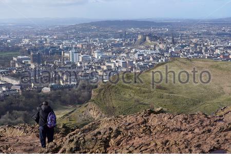 Edinburgh, Schottland, Großbritannien. Februar 2021, 25th. Menschen genießen die Sonne und im Freien im Holyrood Park. Vom Gipfel des Arthurs Sitz mit Blick auf Edinburgh Castle. Kredit: Craig Brown/Alamy Live Nachrichten Stockfoto