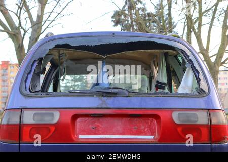 Das Detail eines verlassenen kaputten Autos, jetzt ein Wrack mit beschädigten oder gebrochenen Fenstern und voller Müll oder Abfall. Nimmt einen Parkplatz für den anderen Stockfoto