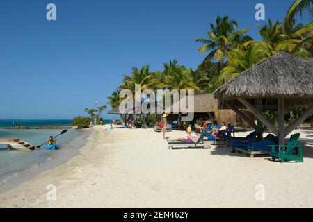 Palapas am Sandstrand am Bitter End Yacht Club, Gorda Sound, Virgin Gorda, Britische Jungferninseln Stockfoto