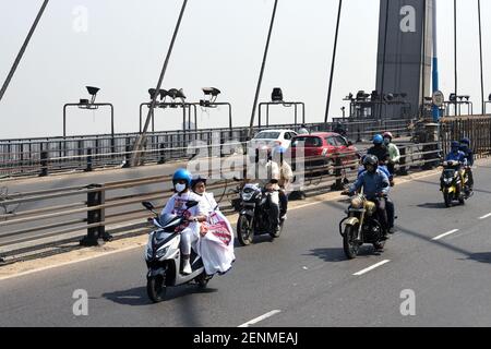 Kalkutta, Indien. Februar 2021, 25th. (2/25/2021) Westbengalen Chief Minister Mamata Banerjee fährt Pillion auf einem Elektroroller, um das Staatssekretariat Nabanna zu erreichen, um gegen Kraftstoffpreisanhebung zu protestieren. (Foto: Ved Prakash/Pacific Press/Sipa USA) Quelle: SIPA USA/Alamy Live News Stockfoto