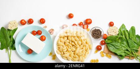 Zutaten für im Ofen gebackenen Feta-Käse mit Tomaten und Nudeln, Pfeffer Knoblauch auf einem hellen Hintergrund Draufsicht. Stockfoto