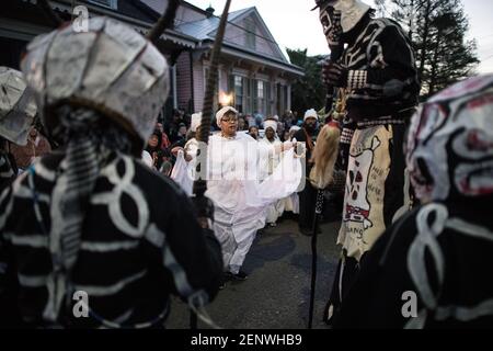 Die Schädel- und Knochenbande mit den Mystic Seven Sisters in den Straßen des New Orleans Mardi Gras Morgen bei Sonnenaufgang. Stockfoto