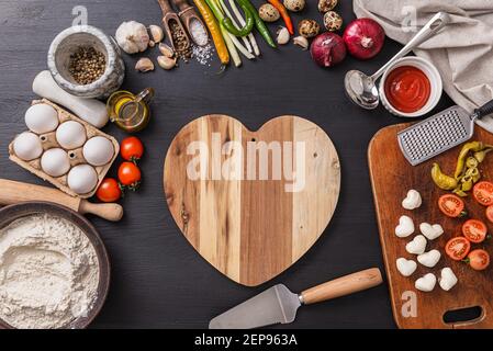 Frau bereitet ein festliches Abendessen für zwei zu Ehren von Valentinstag klassische italienische Pizza Margherita in Form von Ein Herz und Mozzarella im sh Stockfoto