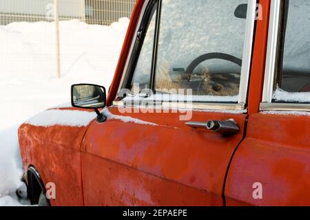 Alte gebrochene vintage rot rostigen Retro-Auto im Winter geparkt Auf Schnee Hintergrund an frostigen Wintertag Stockfoto