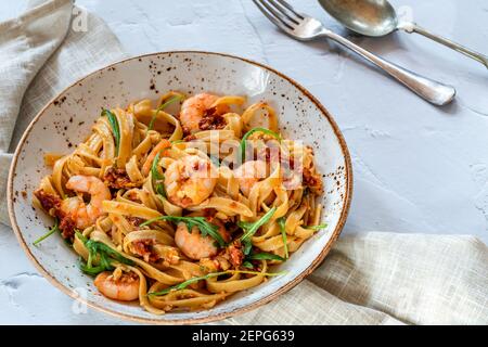 Tigergarnelen in Tomaten, Chili und Mandelpesto mit Fettuccine Pasta Stockfoto