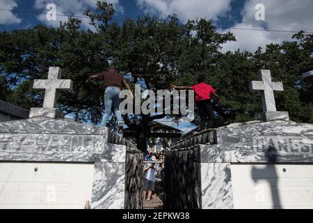 Junge Männer tanzen auf Gräbern und Gräbern auf dem Friedhof während Prince of Wales, New Orleans Social Aid and Pleasure Club Second Line (Second Line). Stockfoto