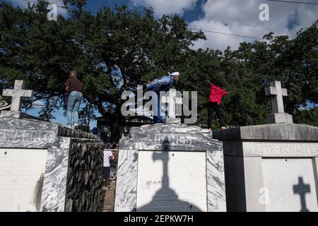 Junge Männer tanzen auf Gräbern und Gräbern auf dem Friedhof während Prince of Wales, New Orleans Social Aid and Pleasure Club Second Line (Second Line). Stockfoto