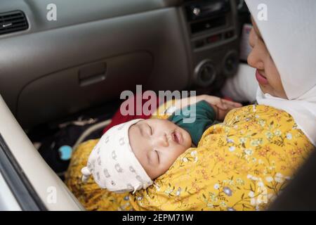 Kleiner Junge mit ihrer muslimischen Mutter im Auto gehen Für eine Reise Stockfoto