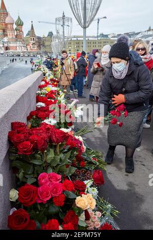 Moskau, Russland. Februar 2021, 27th. Eine Frau, die während der Gedenkfeier Blumen legt. Mehr als 10 Tausend Menschen nahmen am Gedenken an Boris Nemzow am sechsten Jahrestag der Ermordung des Politikers Teil. Unter ihnen sind der ehemalige Ministerpräsident Michail Kasjanow, die Politiker Ilja Jaschin, Dmitri Gudkow, Grigori Jawlinski und Julia Galyamina, die politischen Gefangenen Konstantin Kotow und Anna Pawlikowa und Julia Nawalnaja. Kredit: SOPA Images Limited/Alamy Live Nachrichten Stockfoto