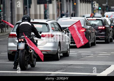 Berlin, Deutschland. Februar 2021, 28th. Ein Auto und ein Motorrad mit der Aufschrift '#AlarmStageRed' fahren während der Autokade der Eventbranche am Bundesministerium der Finanzen vorbei. Quelle: Fabian Sommer/dpa/Alamy Live News Stockfoto