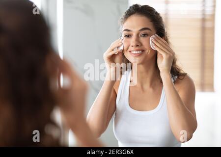 Junge Dame Mit Baumwolle Pads Reinigung Haut Im Badezimmer Stehen Stockfoto