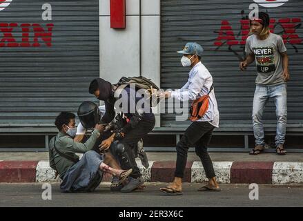 Mandalay, Myanmar. Februar 2021, 28th. Menschen helfen einem Verletzten bei Protesten in Mandalay, Myanmar, am Sonntag, dem 28. Februar 2021. Die Sicherheitskräfte greifen weiterhin auf Demonstrationen gegen den Militärputsch zurück. Foto von Xiao Long/UPI Kredit: UPI/Alamy Live Nachrichten Stockfoto